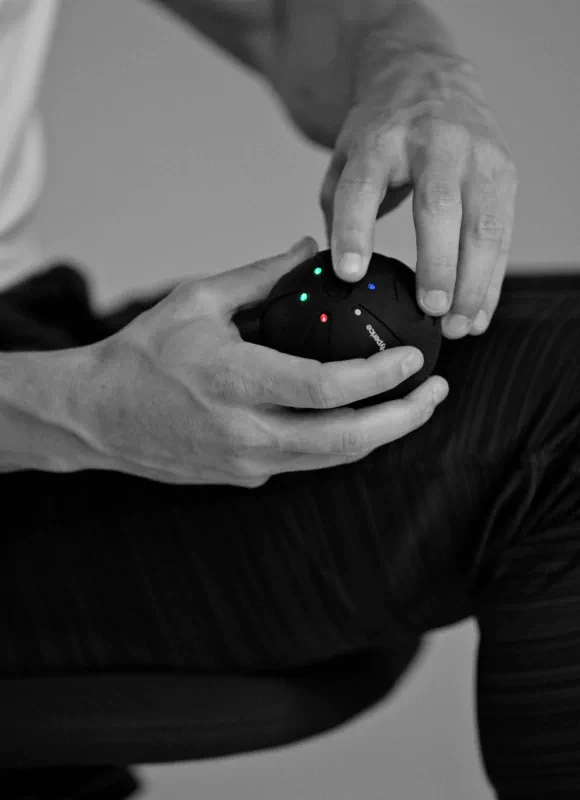 Choosing vibration intensity for the Hypersphere massage ball.